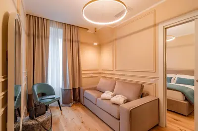 a living room with a couch and a bed at Trevi Imperial Suite 3 in Rome