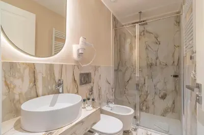 a bathroom with a sink and a toilet and a shower at Trevi Imperial Suite 2 in Rome