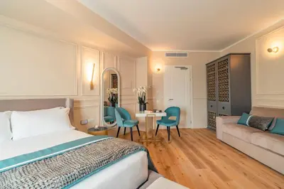 a bedroom with a bed and a couch and a table at Trevi Imperial Suite 1 in Rome