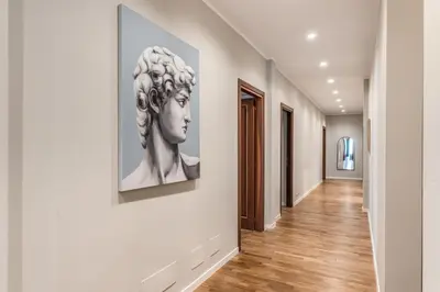 a hallway with a painting of a woman on a wall at DOWNTOWN SRL - The Great Court and The Great Chill in Rome