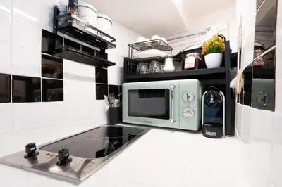a microwave sitting on a counter in a kitchen at Flowers' Circle of piazza di Spagna in Rome