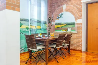 a dining room with a table and a mural at la casa dell'agrumeto in Rome
