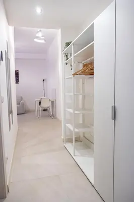 a room with white shelves and a table at A un passo da San Pietro in Rome