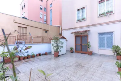 a courtyard in a building with potted plants at Casa Arco Roma in Rome