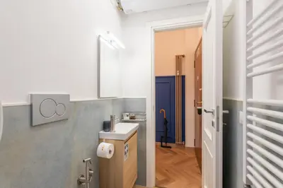 a small kitchen with a sink and a door at Casa Vacanze Ourplaces Sacchetti in Rome
