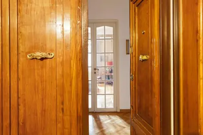 an open wooden door in a room with a door at Casa Augusta, a Burghesius home in Rome