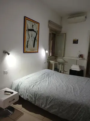 a bedroom with a bed and a picture on the wall at Guest House San Pietro in Rome