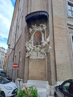 a building with a statue on the side of it at Home Piazza Dell'Orologio in Rome