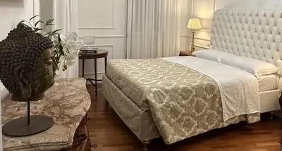 a bedroom with a bed and a vase on a table at Alloggio turistico King Plaza in Rome