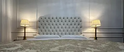 a bedroom with a large bed with two lamps at Alloggio turistico King Plaza in Rome