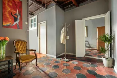 a living room with a chair and a mirror at Dimora Florea - in the heart of Campo de' Fiori in Rome