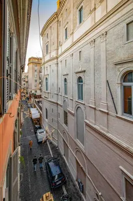a view of a street between two tall buildings at Dimora Florea - in the heart of Campo de' Fiori in Rome