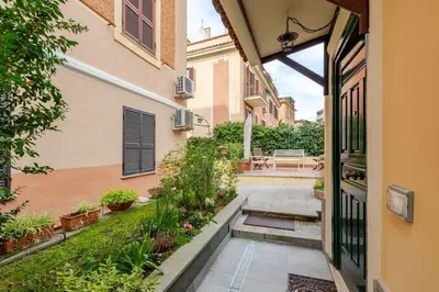 an entrance to a building with a courtyard with plants at Cottage San Giovanni in Rome