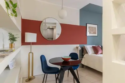 a living room with a table and chairs at GuestHost - Aurea Domus Comfort suite in centro a Roma in Rome