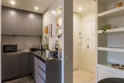 a kitchen with white cabinets and a counter top at GuestHost - Aurea Domus Comfort suite in centro a Roma in Rome