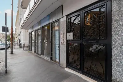 a store front with wrought iron doors on a street at GuestHost - Aurea Domus Comfort suite in centro a Roma in Rome