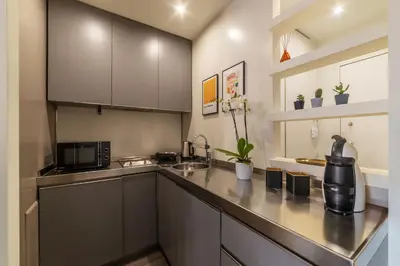 a kitchen with a sink and a microwave at GuestHost - Aurea Domus Comfort suite in centro a Roma in Rome
