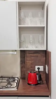 a red tea kettle sitting inside of a cabinet at Il Cortile del 900 in Rome