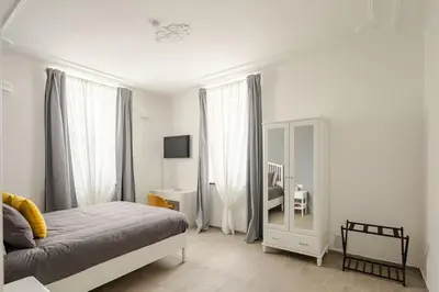 a bedroom with a bed and a mirror at Design Apt Moderno Pzz del Popolo - Parking in Rome