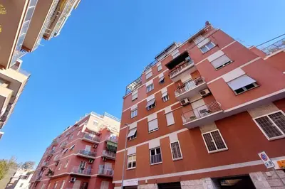 a tall red brick building with balconies on it at La Dolce Vita - Vatican Studio with Large Terrace in Rome