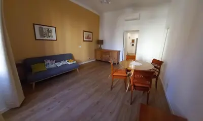 a living room with a blue couch and a table at Il regno dei colori in Rome