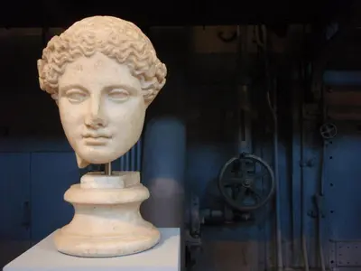 a statue of a head on a stand in a museum at B&B Colori di Roma in Rome