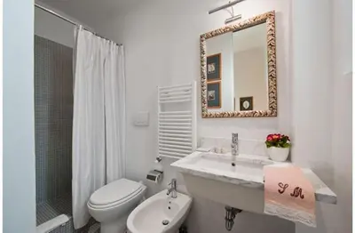a bathroom with a sink and a toilet and a mirror at B&B Colori di Roma in Rome