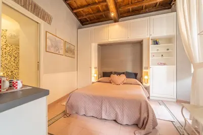 a bedroom with a large bed in a room at Secret Studio Retreat in the Heart of the Ghetto by Houseeds in Rome