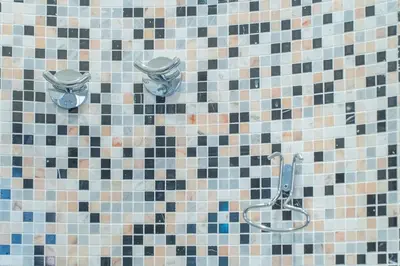 a tiled bathroom with a shower and a toilet at Secret Studio Retreat in the Heart of the Ghetto by Houseeds in Rome