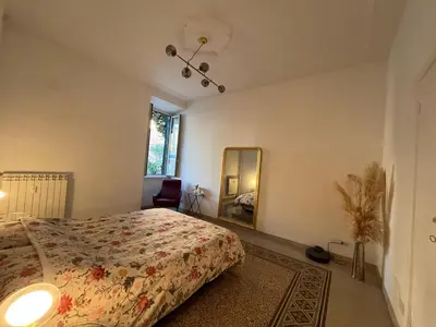 a bedroom with a bed and a mirror at Charming Apartment in San Pietro in Rome