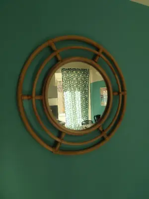 a mirror hanging on a wall with a curtain at Colosseum Studio Flat blue in Rome