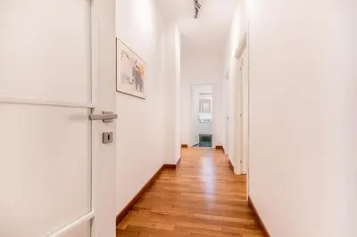 a hallway with white walls and a wooden floor at Zampieri Loft in Rome