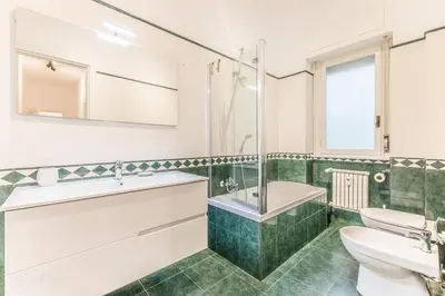 a bathroom with a sink and a tub and a toilet at Zampieri Loft in Rome