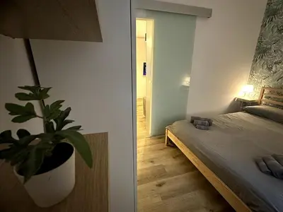 a bedroom with a potted plant next to a bed at Il Rifugio dell Inventore in Rome