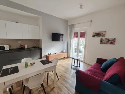 a kitchen and living room with a table and a couch at Domus MT481 in Rome