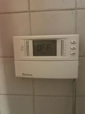 a digital clock on a wall in a bathroom at Vacanze al Colosseo Polveriera in Rome