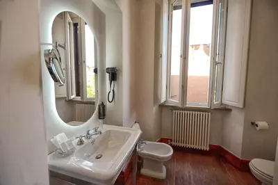a bathroom with a sink and a toilet and a mirror at AGH Babuino in Rome