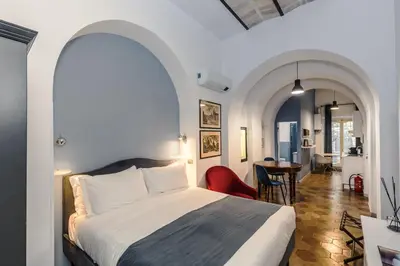 a hotel room with a bed and a dining room at Vatican Home in Rome