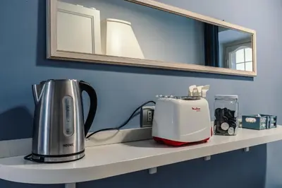 a counter with a coffee maker and a toaster on it at Vatican Home in Rome