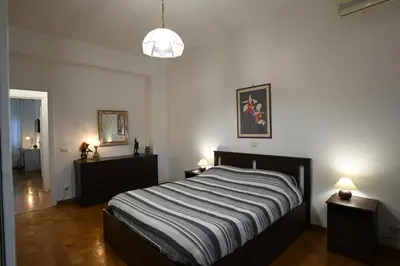 a bedroom with a bed and two night stands at Vatican Firefly House in Rome