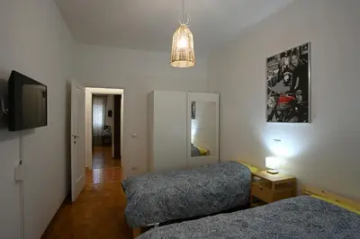 a bedroom with two beds and a flat screen tv at Vatican Firefly House in Rome
