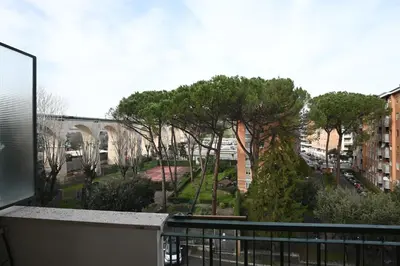 a balcony with a view of a street and trees at Vatican Firefly House in Rome