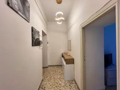 a hallway with a room with a table and a mirror at appartamento elegante Roma - Vicino alla metro in Rome