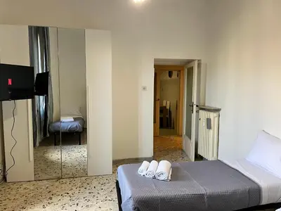 a bedroom with a bed with two white slippers on it at appartamento elegante Roma - Vicino alla metro in Rome