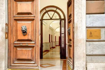 an entrance to a building with a wooden door at La Casina Vaticana in Rome