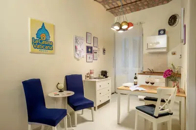 a dining room with blue chairs and a table at La Casina Vaticana in Rome