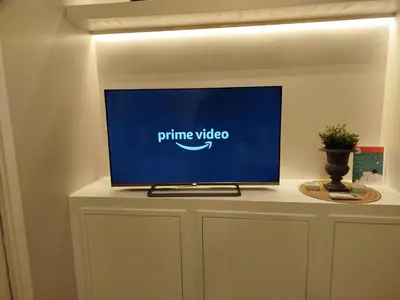 a flat screen tv on top of a white cabinet at Pon Pon Sweet Home in Rome