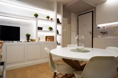 a white dining room with a white table and chairs at Pon Pon Sweet Home in Rome