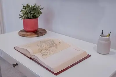 an open book on a table with a potted plant at La Casetta di San Giovanni in Rome