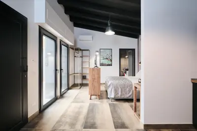 a bedroom with a bed and a table at Le Arcate, suite 1 Lavinia, suite 2 Lucilla in Rome